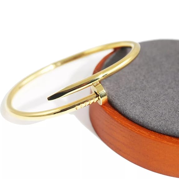 Gold bracelet on a round brown and gray object