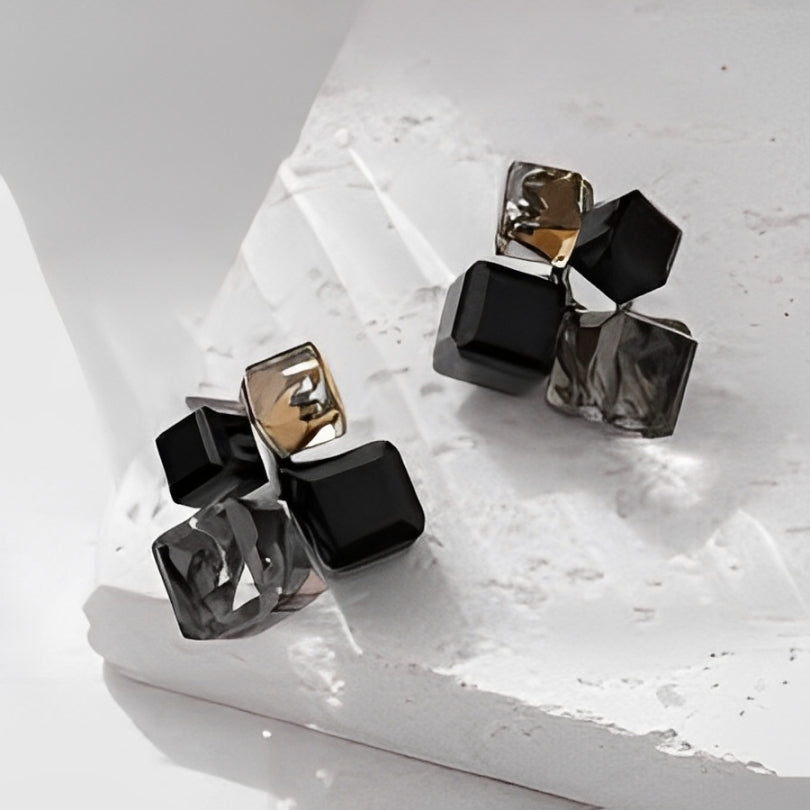Pair of geometric earrings on a light surface
