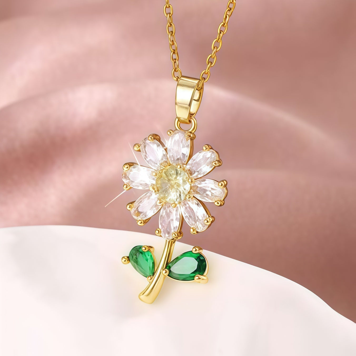 Gold necklace with a flower-shaped pendant on a pink background