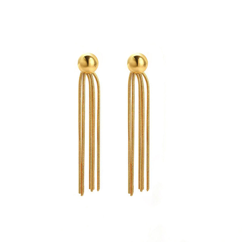 Gold tassel earrings on a white background
