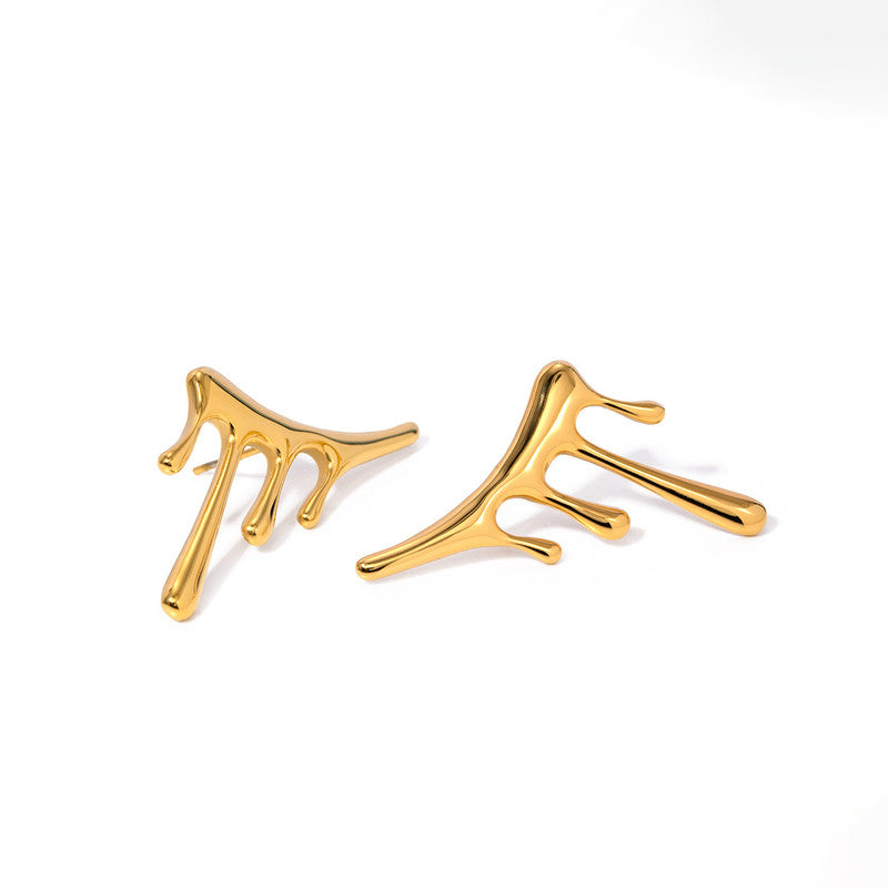 Gold branch-like earrings on a white background