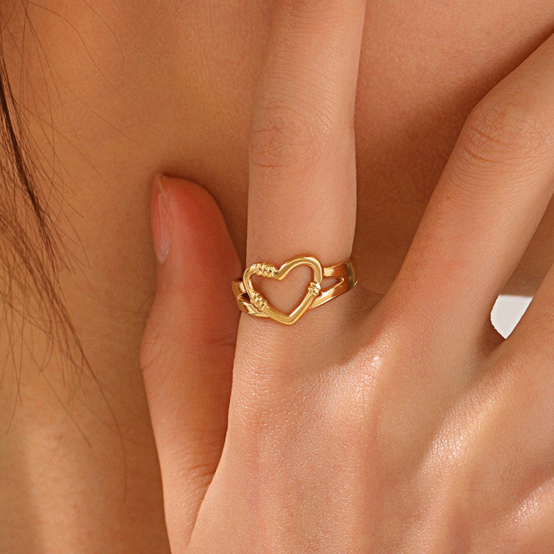 Gold heart-shaped ring on a finger