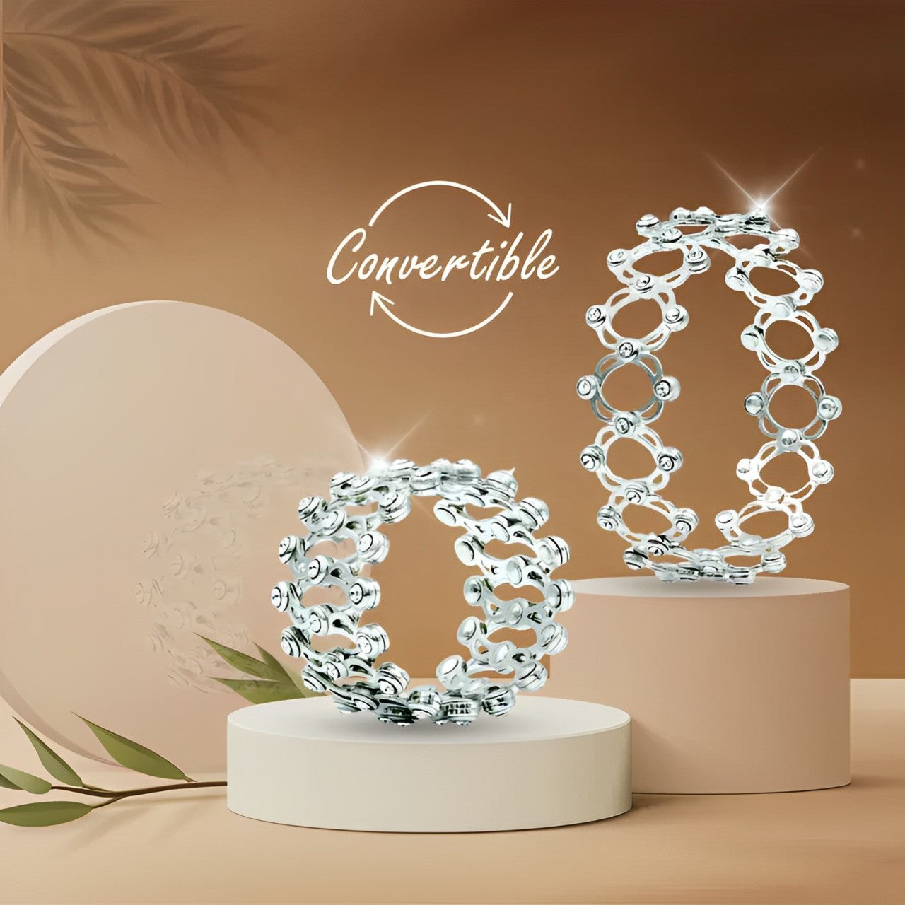 Silver convertible bracelet on a beige stand with a brown background