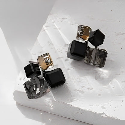 Pair of geometric earrings on a light surface